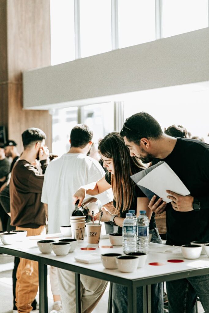 Colleagues pour coffee during a business meeting in Baku, fostering teamwork.