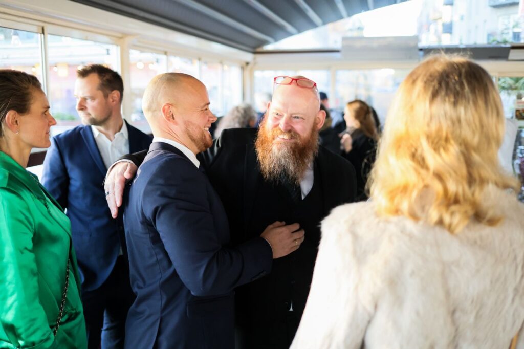 Candid scene of business professionals enjoying a jovial moment together indoors.